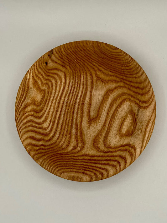 This is a small bowl made from ash. It's about 8 inches in diameter and about 2 inches deep. This bowl would make a great piece for entertaining. Great for nuts, candy, or any small finger foods.          